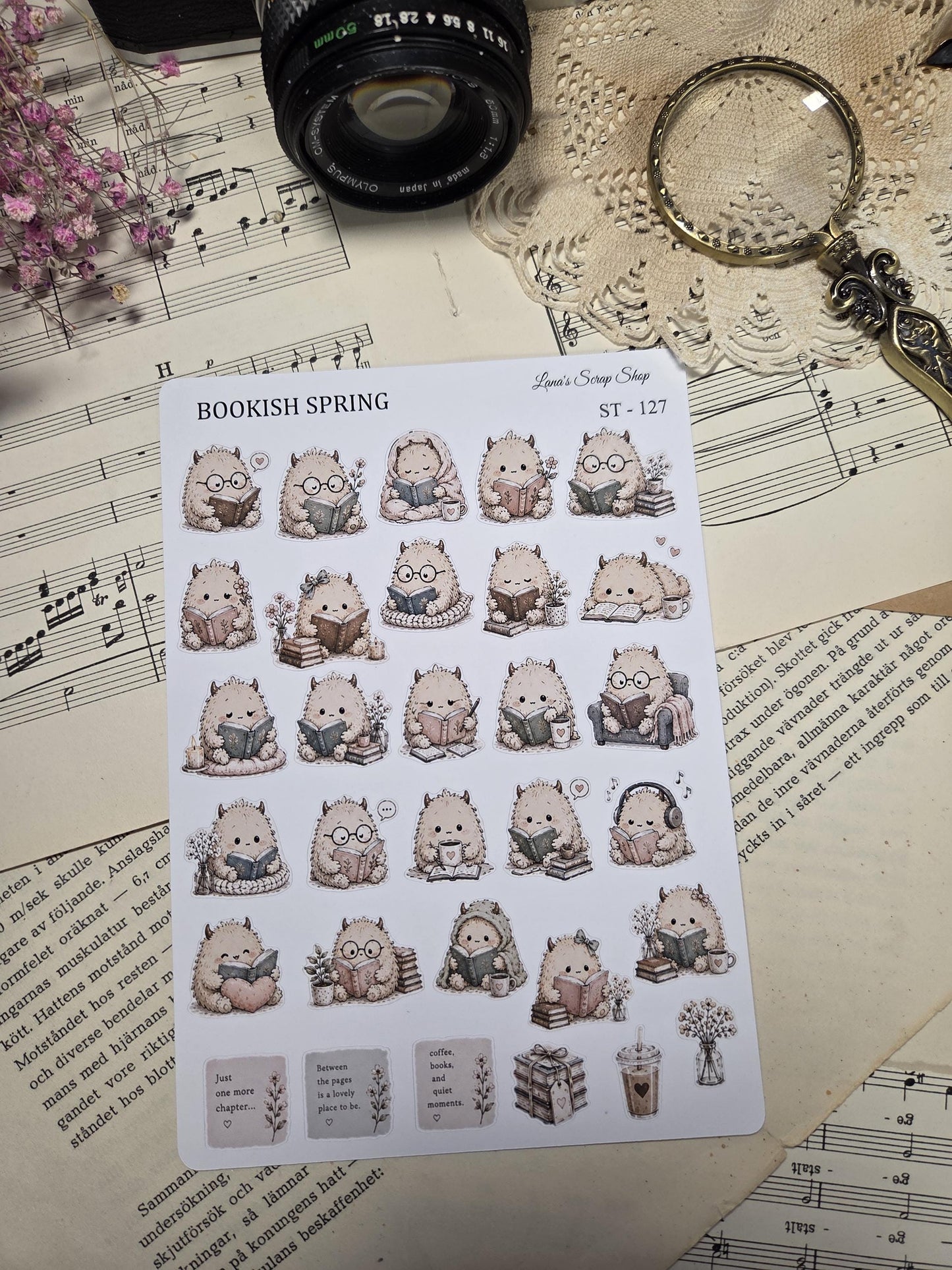 A sticker sheet with illustrations of adorable, fluffy creatures reading books, wearing glasses, and drinking coffee. The sheet is titled "BOOKISH SPRING" and includes small text boxes with quotes and floral accents. The stickers are in soft, muted colours.