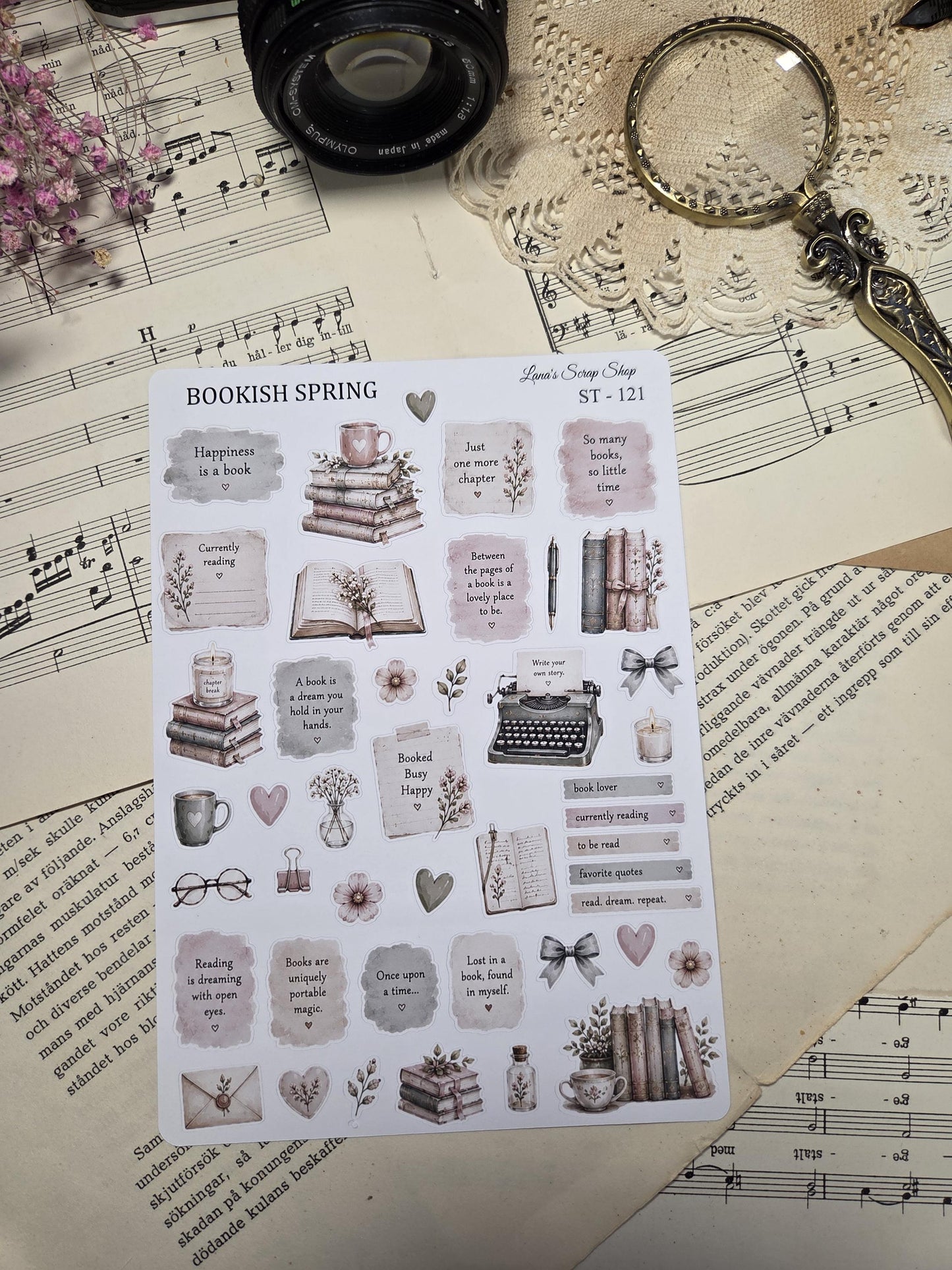A sticker sheet with a "Bookish Spring" theme, featuring illustrations of books, teacups, and floral elements. Text includes phrases like "Happiness is a book" and "So many books, so little time." The design has a vintage, scrapbook style.