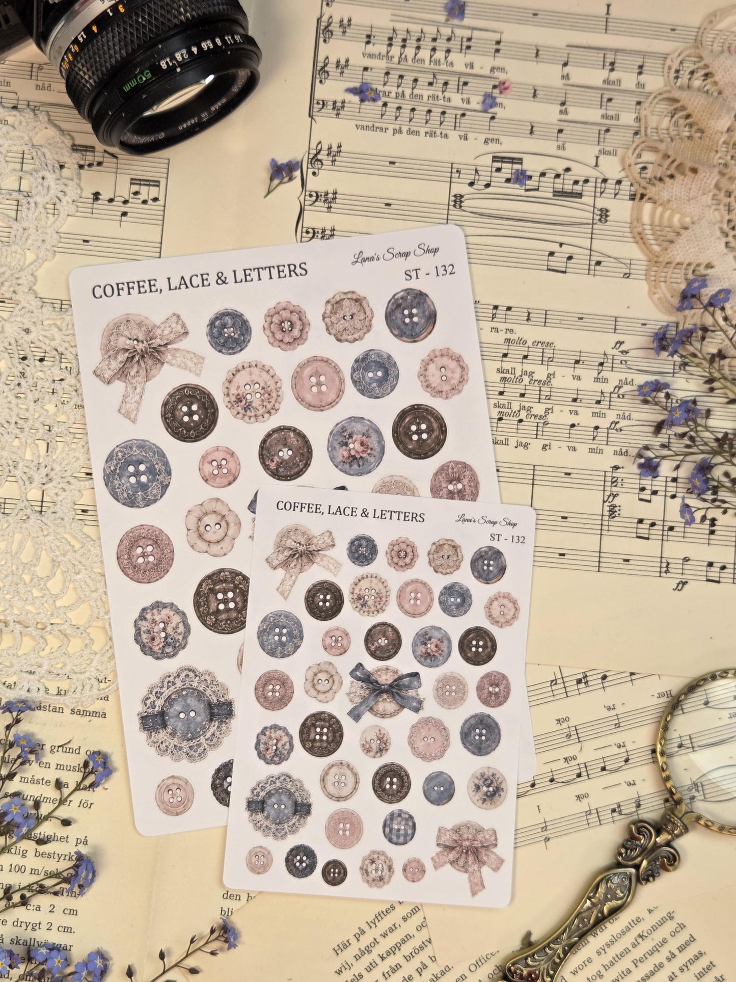 Vintage journaling stickers with lace ribbons, buttons, bows, and delicate decorative elements in soft pastel blue and blush colors for scrapbooking.